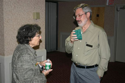 Lois Berger and Denis Nelson trade stories before the meeting