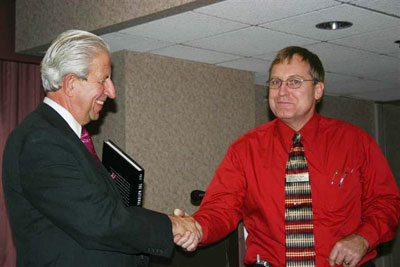 Dr. Hapsburg receives our gift book from Chapter President Toby Fitzkee