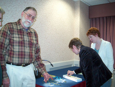 Courtland Lee showing his collection to Melanie Marts and Allison Brady