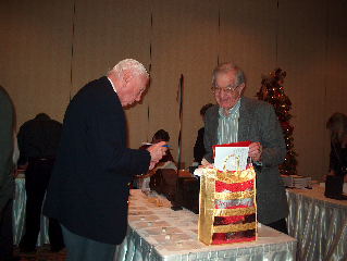 Bob Davis and Hap Williams look over the silent auction items