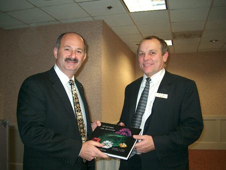 Chapter VP Tony Conway presents our gift Smithsonian book to Bill Boyajian at the end of the meeting.