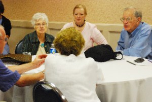 A table of members having a pre meeting discussion